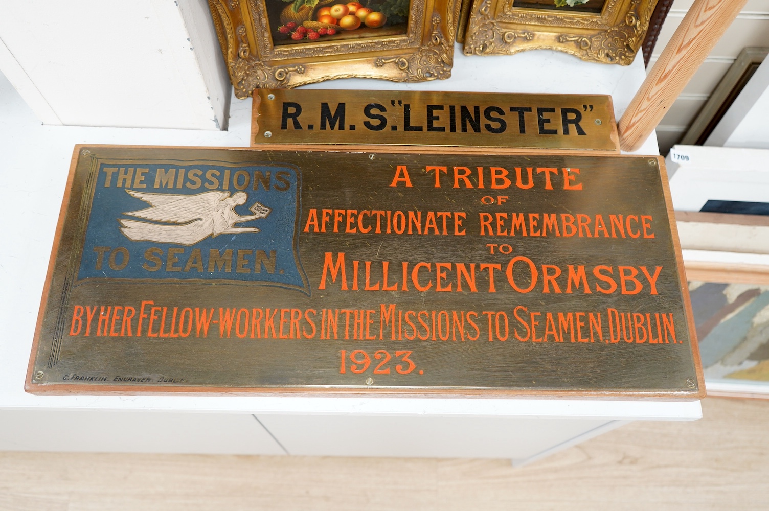 A brass plaque for a tribute of remembrance to Millicent Ormsby the missions to the seamen, Dublin, 1923, engraved by C Franklin and another for RMS Leinster. Condition - fair